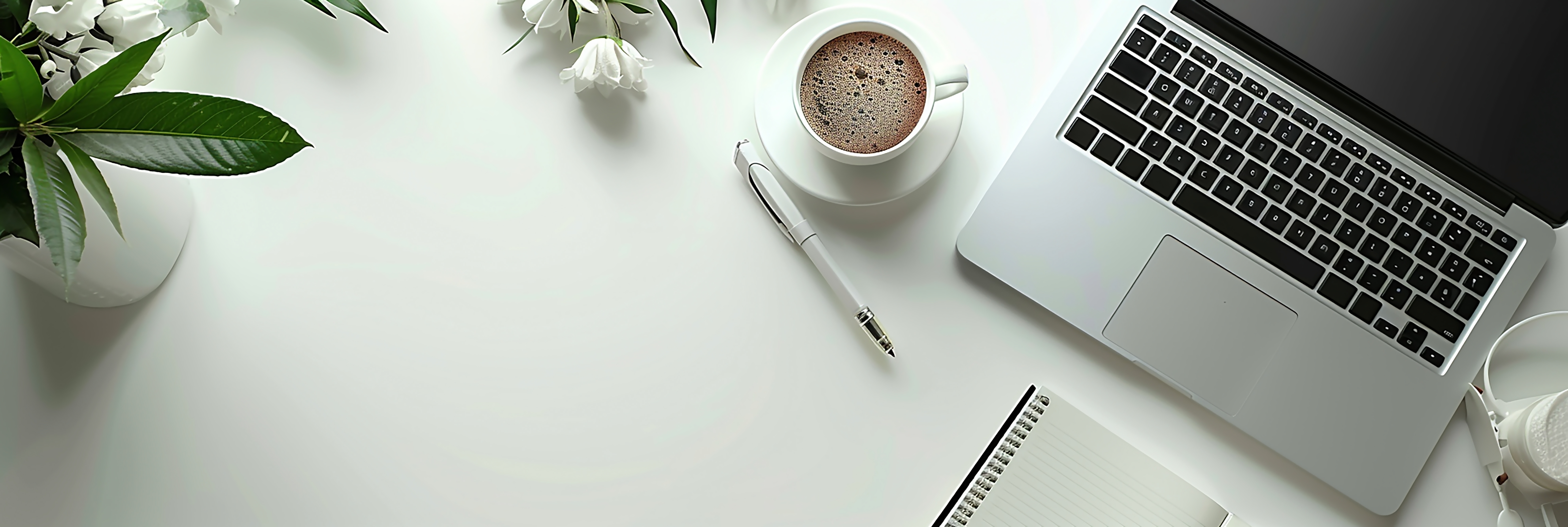 Laptop workspace with coffee and notebook